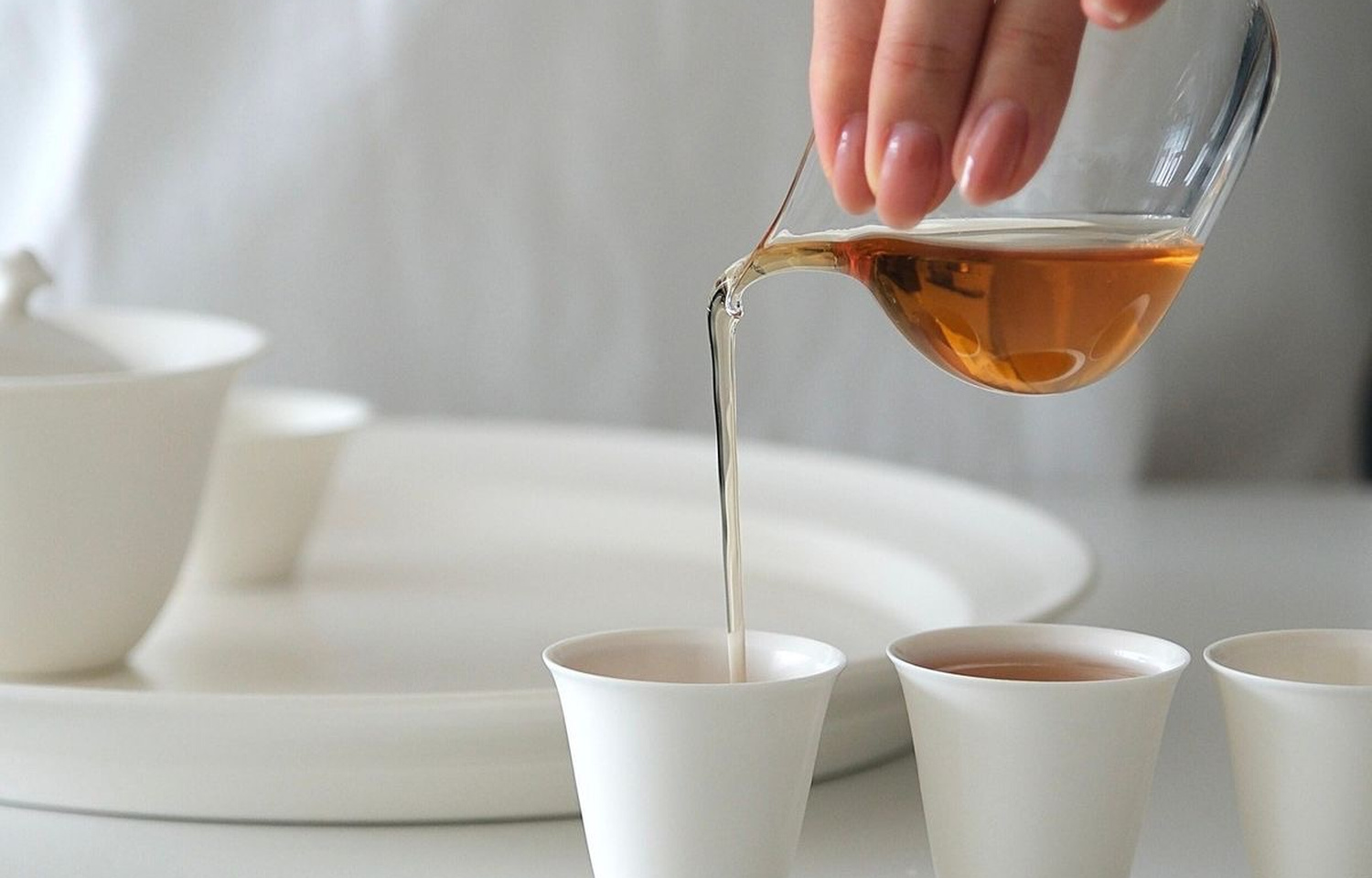 Tea poured beside a white gaiwan